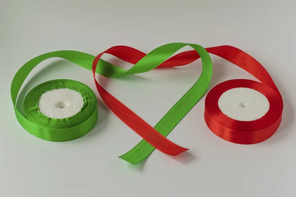 A roll of satin ribbon for decorating gifts on a white background. Silk and satin ribbon.