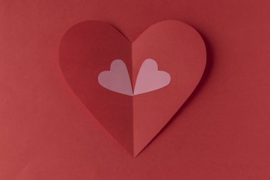 Red paper heart on a red background. Valentine's Day. Valentine's Day. Love and heart