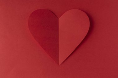 Red paper heart on a red background. Valentine's Day. Valentine's Day. Love and heart
