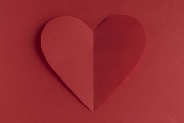 Red paper heart on a red background. Valentine's Day. Valentine's Day. Love and heart