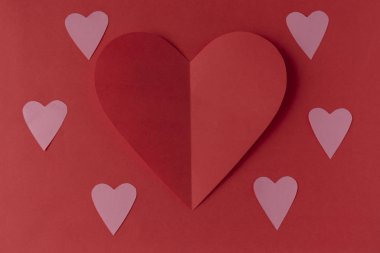 Red paper heart on a red background. Valentine's Day. Valentine's Day. Love and heart