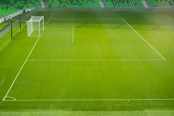 Football soccer field with white marks, green grass texture and corner. — Stockfoto