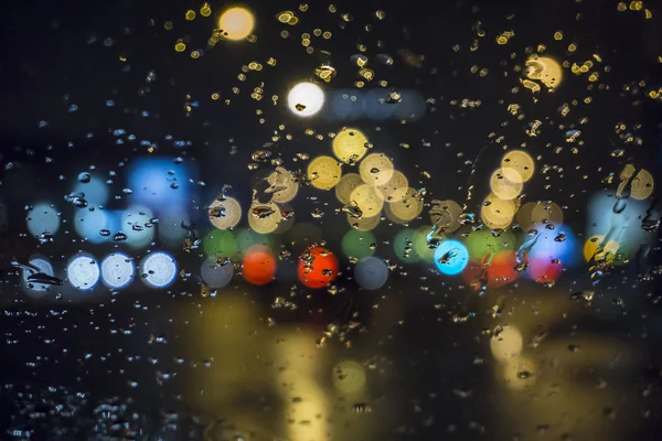 Wet the window with the background of the night city traffic view. — Stock Photo, Image