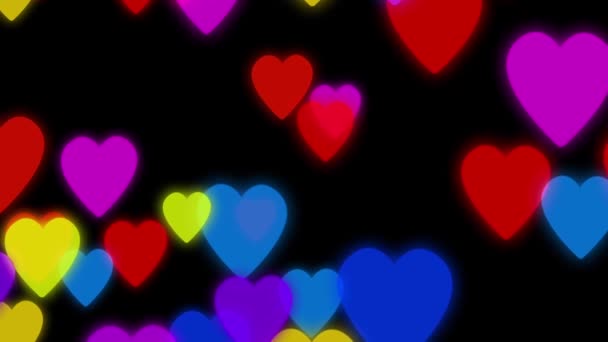 Animación de fondo de corazones. Corazones coloridos cayendo lentamente sobre un fondo oscuro con partículas que fluyen alrededor — Vídeo de stock