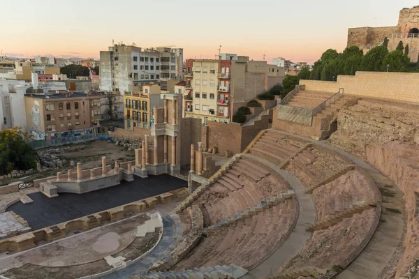 Aerial panoramic view of port city Cartagena in Spain with famous roman amphitheater. Beautiful sunset over the mountains. Wide angle lens panorama