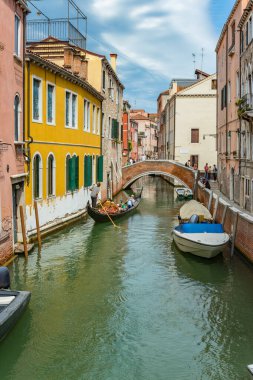 Venedik, İtalya - 02 Ağustos 2019 Venedik 'te güneşli bir günde binlerce güzel köşeden biri. Yerel halk ve turistler demirlemiş teknelerle tarihi binalar ve kanallar boyunca geziniyorlar.