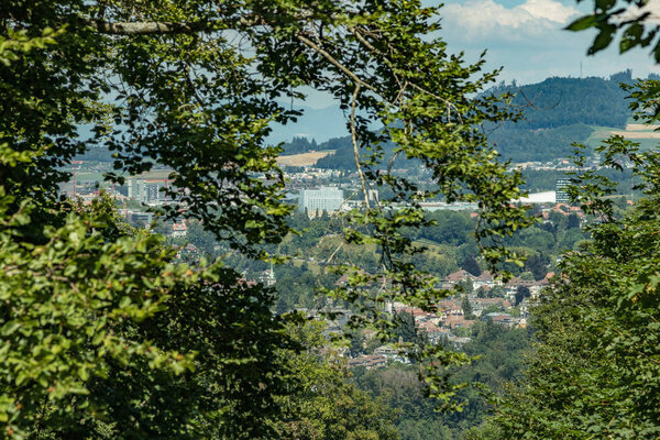 Bern, Switzerland - July 30, 2019: Panoramic view at sunny summer day fro the top of Gurten Mountain Park. Telephoto lens shot.