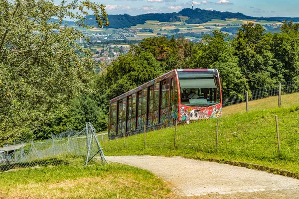The Gurten funicular lets you to reach a paradise of green meadows and breathtaking views of the snowy caps of the Bernese Oberland region, the sparkling Aare river and the city of Bern, Switzerland
