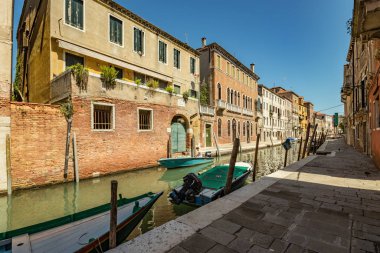 VENICE, ITALY - August 03, 2019: Narrow pedestrian streets of Venice bitween the channels. Some quiet places almost without people.