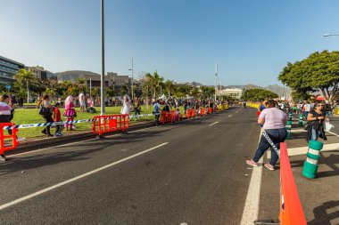 SANTA CRUZ DE TENERIFE, SPAIN - FEBRUARY 25, 2020: The beginning of Coso - final parade of the carnival. Spectators and locals occupy the last vacant positions.
