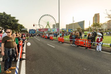 SANTA CRUZ DE TENERIFE, SPAIN - FEBRUARY 25, 2020: The beginning of Coso - final parade of the carnival. Spectators and locals occupy the last vacant positions.