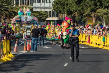 SANTA CRUZ DE TENERIFE, SPAIN - FEBRUARY 25, 2020: The beginning of Coso - final parade of the carnival. Spectators and locals occupy the last vacant positions.