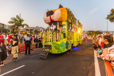 SANTA CRUZ DE TENERIFE, SPAIN - FEBRUARY 25, 2020: Coso parade - along the Avenida de Anaga, official end of Carnival. Again march carnival groups, floats, decorated cars and the Carnival Queens. clipart