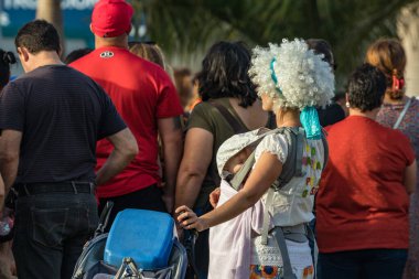 SANTA CRUZ DE TENERIFE, SPAIN - FEBRUARY 25, 2020: Around the Coso parade - along the Avenida de Anaga, official end of Carnival. Amazing warm evening, joyful people in carnival costumes have fun.
