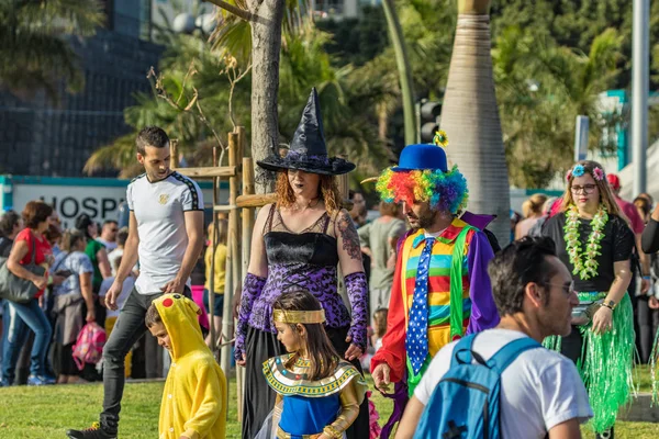 SANTA CRUZ DE TENERIFE, SPAIN - FEBRUARY 25, 2020: Around the Coso parade - along the Avenida de Anaga, official end of Carnival. Amazing warm evening, joyful people in carnival costumes have fun.