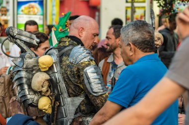 SANTA CRUZ DE TENERIFE, SPAIN - FEBRUARY 25, 2020: Around the Coso parade - along the Avenida de Anaga, official end of Carnival. Amazing warm evening, joyful people in carnival costumes have fun.