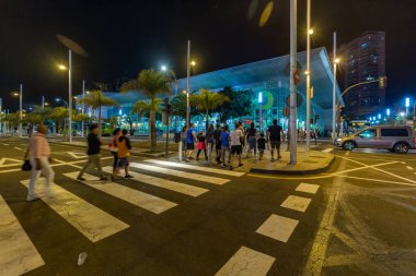 SANTA CRUZ DE TENERIFE, SPAIN - FEBRUARY 25, 2020: Around the Coso parade - along the Avenida de Anaga, official end of Carnival. Amazing warm evening, joyful people in carnival costumes have fun.
