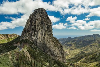 Agando rock in La Gomera island. A volcanic plug, also called a volcanic neck or lava neck, is a volcanic object created when magma hardens within a vent on an active volcano. clipart