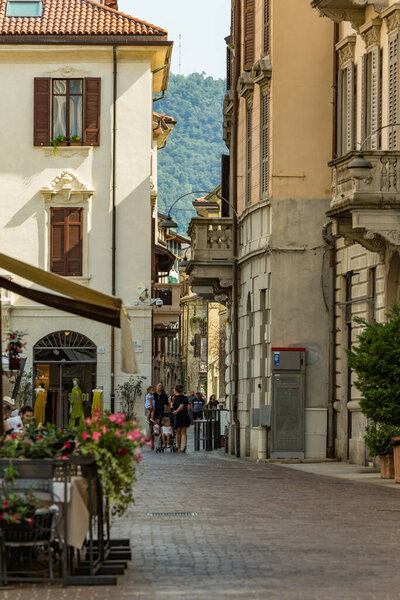 Como, ITALY - August 4, 2019: Local people and tourists on a quiet cozy streets in the center of beautiful Italian Como city. Warm sunny summer day in very popular holiday destination.
