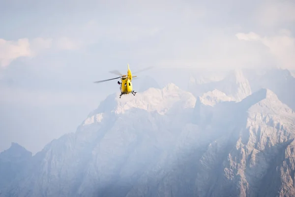 Medical rescue helicopter in air. Italian Dolomites.