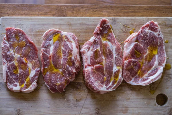 raw pork chop steaks ready for a grill