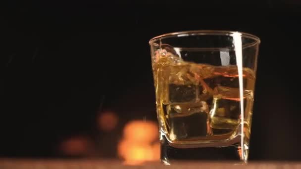 Cubes Cold Ice Fall Glass Whiskey Background Burning Fire Fireplace — Stock Video