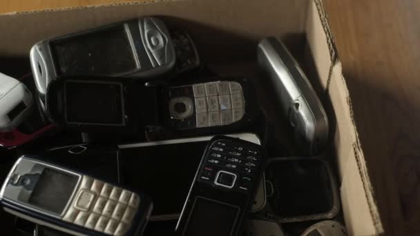Outdated Cell Phones Big Pile Cardboard Box Old Broken Scratched — Stock Video
