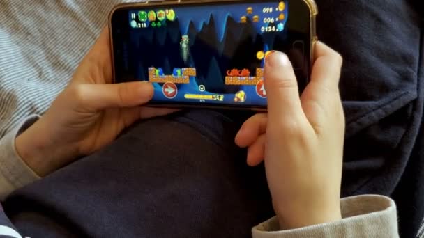 Küçük çocuk akıllı telefondan mobil oyunlar oynuyor, çocukların eğitim teknolojisi... — Stok video
