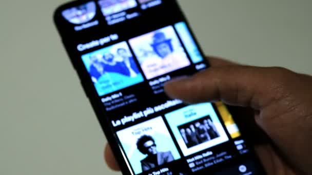 Man browsing Spotify App genre catalog On A Smartphone, streaming music platform — стоковое видео