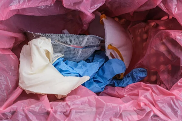 Medical dirty protective mask and gloves in garbage bin,coronavirus disease equipment