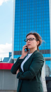 Güzel bir iş kadınının portresi. Ciddi ve endişeli bir ifadeyle konuşuyor. Beklenmedik haberler dinliyor..