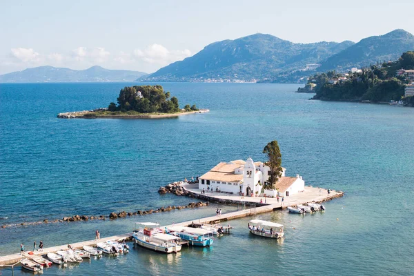 Europe Greece Corfu travel vacation.Panoramic view of orthodox christian Vlacherna Monastery and mouse island. Panoramic view of sea, island with old historical buildings and mountains in sunny