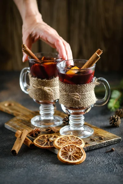 Female Hand Takes Glass Mulled Wine Dark Background Spruce Branch — Stock Photo, Image