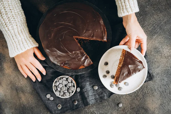 Traditional italian chocolate cake with apples and cinnamon on a dark background