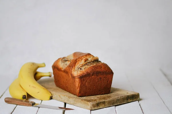 Banana bread with bananas on a light background copy space.