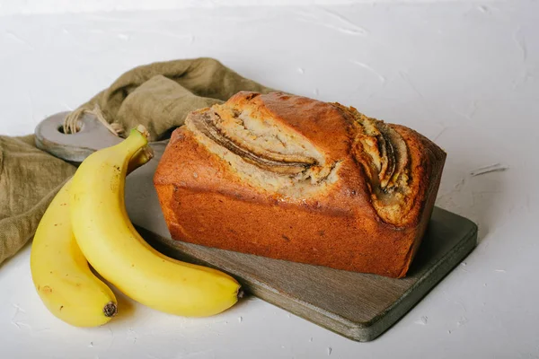 Banana bread with bananas on a light background copy space.