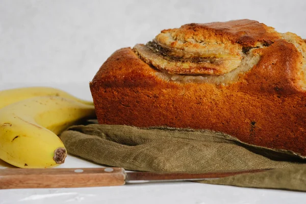 Banana bread with bananas on a light background copy space.