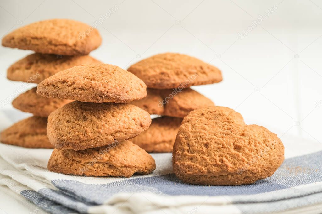 Ginger cookie on a light napkin on a light background top view copy space.