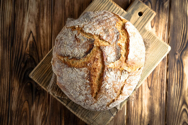Delicious homemade bread on a napkin on rustic background.