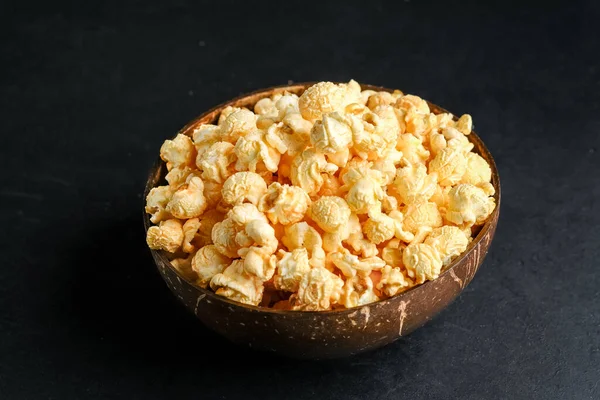 Popcorn. Cheese and caramel popcorn on a dark background. Top view copy space.