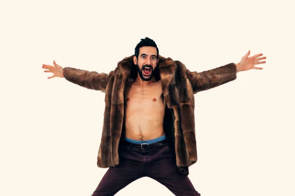 man in fur blows crazy with joy opening his arms with a surprised and amused expression - jumping for happiness and craziness