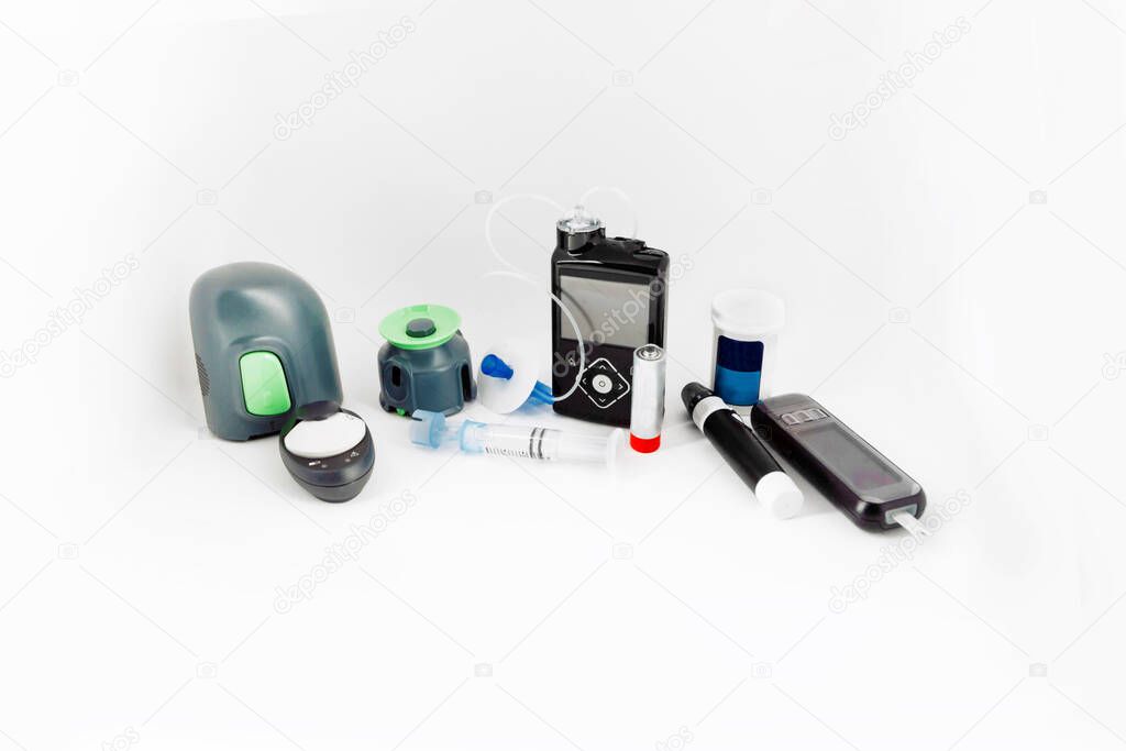 diabetic items on white background used for the diabetes healthcare insulin pump - test - monitor - insulin pen - blood sugar meter - glucose injection