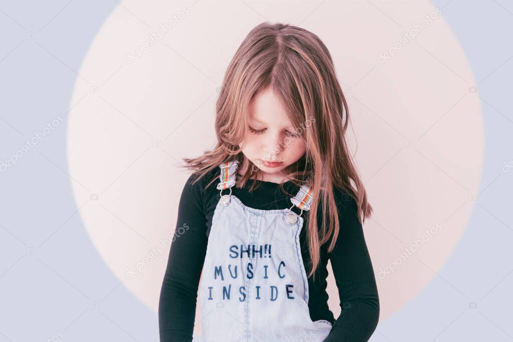 portrait of a young girl with long hair and closed eyes wearing a dungarees with the text shh!! music inside - youth intimacy personal confidence concept