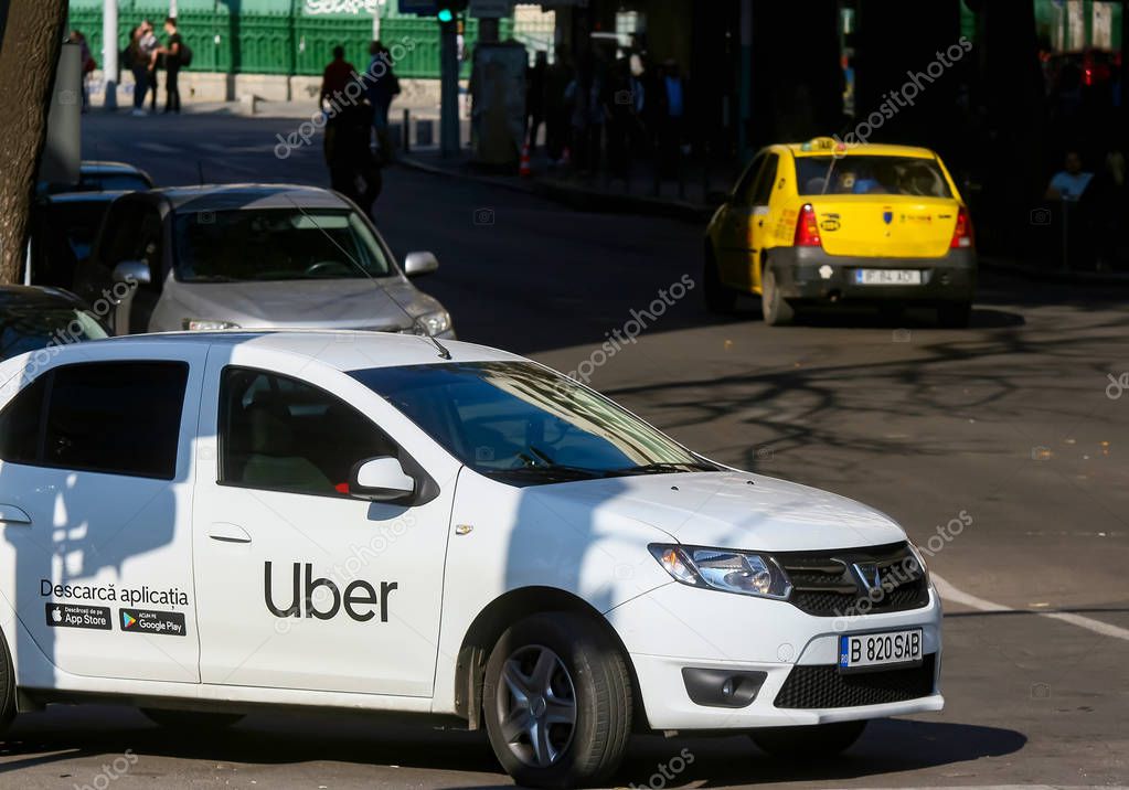 Bucharest, Romania - October 14, 2019: An Uber logo branded car is seen in traffic on a street in downtown Bucharest.