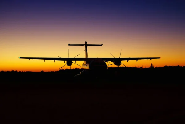 propeller airplane silhouette at the colorful sunset