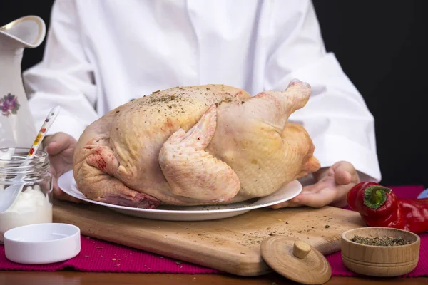 Boy chef prepares a  chicken — Stock Photo, Image