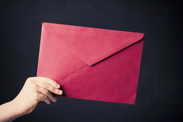 Red mail envelope holds