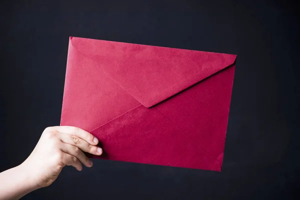 Red mail envelope holds