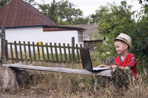 The boy is looking at laptop — Stock Photo, Image