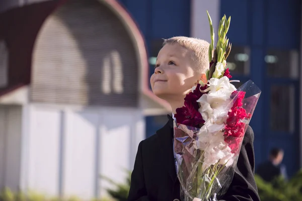 Boy in a suit with a bouquet — Stock Photo, Image